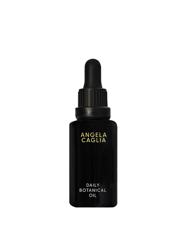 Front view of Daily Botanical Oil showing black glass dropper bottle with gold Angela Caglia logo on white background